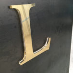 Brass lettering with acrylic backing